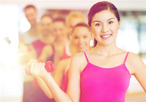 Group Of Smiling People With Dumbbells In The Gym Stock Image Image Of Fitness Bodycare 82194043