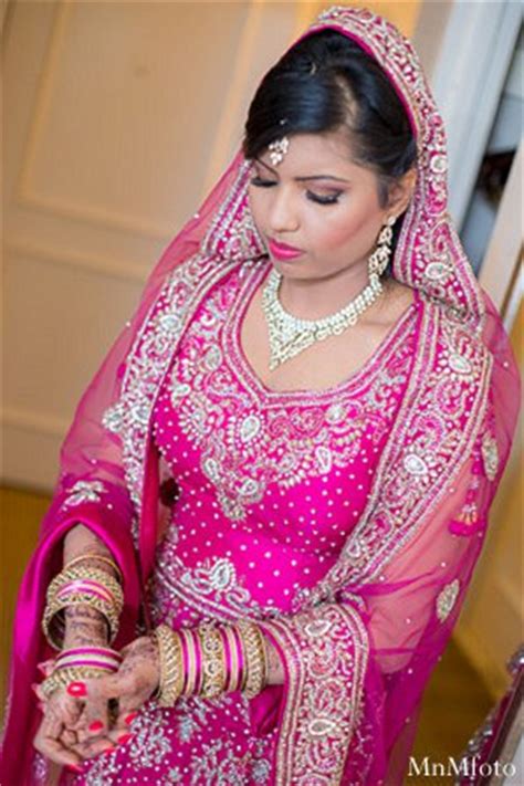 Net wedding lehenga choli in pink purple color. Alexandria, VA Indian Wedding by MnMfoto | Maharani Weddings