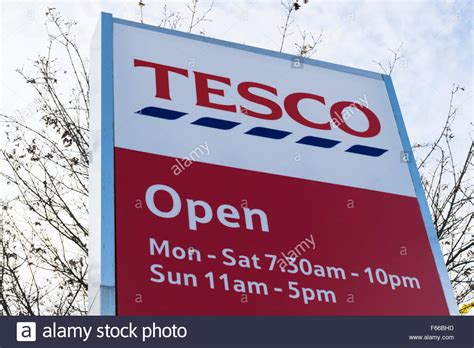 Find tesco by location (town or city). Tesco sign - with opening hours Stock Photo: 89880601 - Alamy