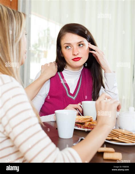 Young Woman Comforting Depressed Friend In Home Stock Photo Alamy