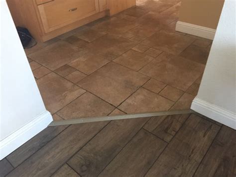 This hardwood transition strip is shaped to make smooth transition from a lower vinyl floor upward to a thicker ceramic or stone tile floor. Transition options tile to laminate