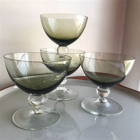 Three Wine Glasses Sitting On Top Of A Table