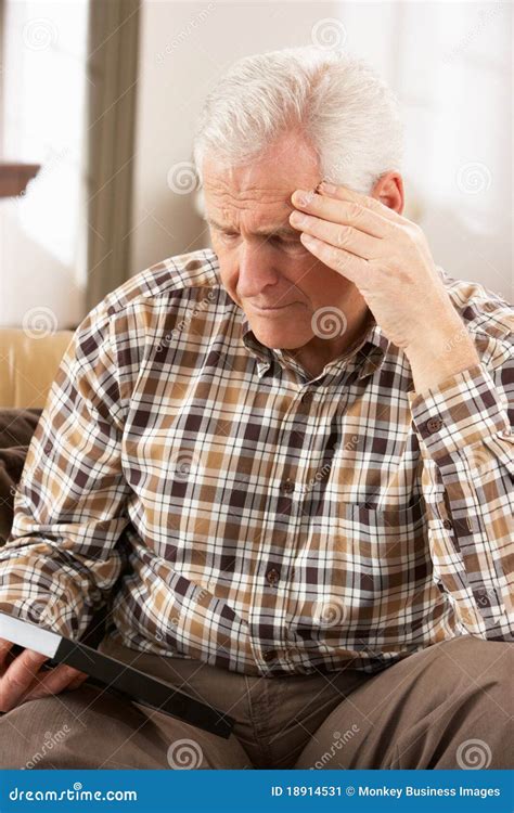 Sad Senior Man Looking At Photograph Stock Image Image Of Seventies