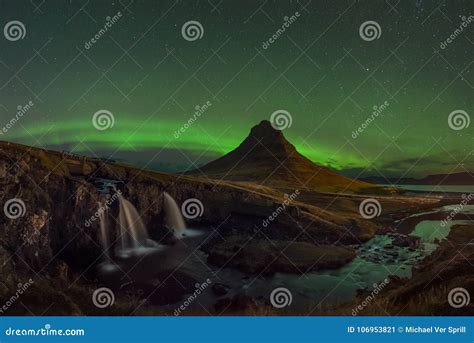Aurora Borealis Over Kirkjufellsfoss And Kirkjufell Mountain Stock