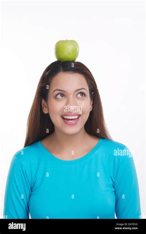 Woman Balancing Apple On Head Stock Photo Alamy