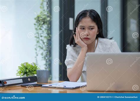 Young Asian Businesswoman Working On Laptop Computer Stressed Has A