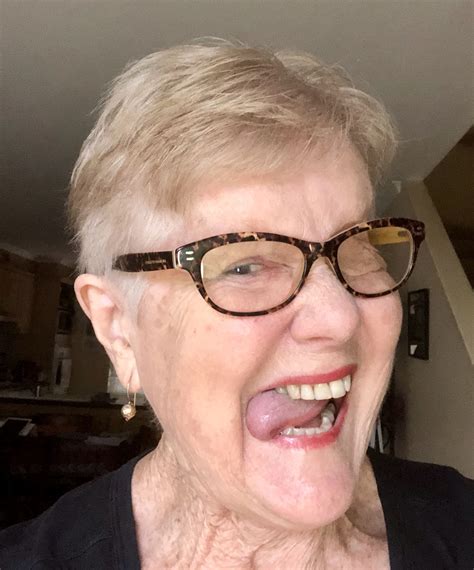an older woman with glasses making a funny face