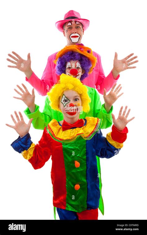 Three People Dressed Up As Colorful Funny Clowns Over White Background