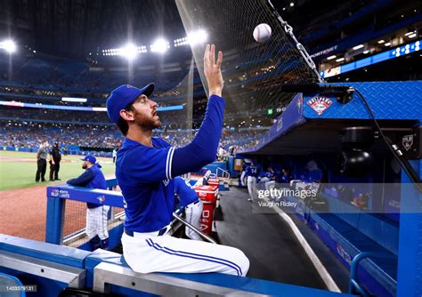 Jordan Romano Of The Toronto Blue Jays Throws A Ball To A Fan After