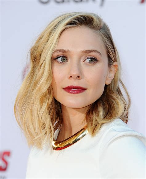 Elizabeth olsen loves her avengers character, but if she had it her way, she would tweak the costume just a little bit. Shimmery red lips: we're on board.