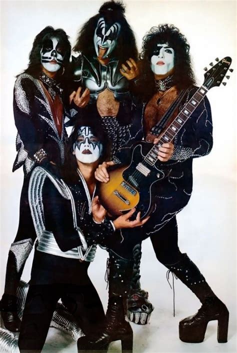 Kiss Band Members Posing With Their Guitars