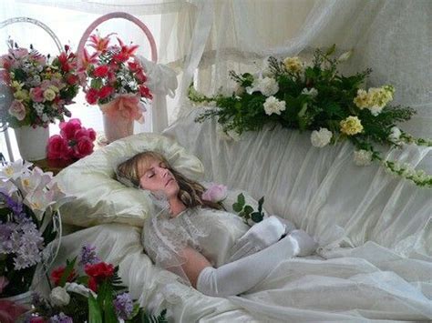 Preparing a dead body in the casket. Woman in her open casket at a fantasy funeral.