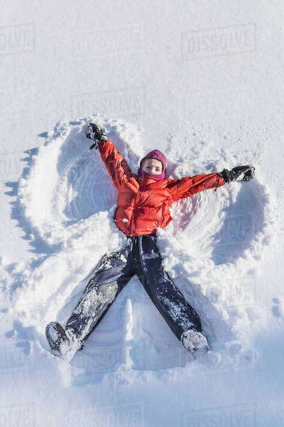 Young Girl Making A Snow Angel In Wintertime Talkeetna Alaska United