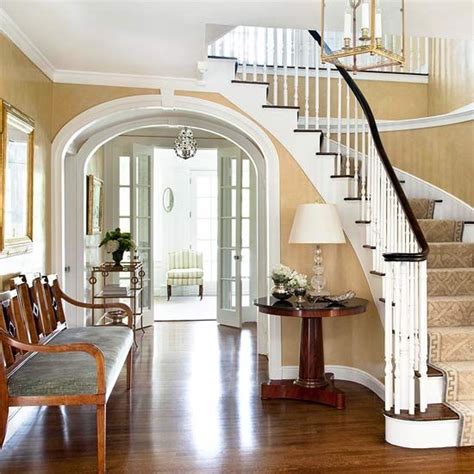 Elegant Traditional Foyer With Curved Staircase And Arched
