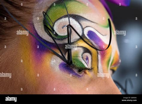 Female Model Portrait With Tribal Creative Make Up Swirl And Purple