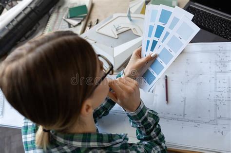 Female Interior Designer Working In Office With Color Palette