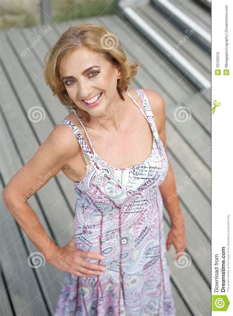 Beautiful Older Woman Posing Outdoors With A Smile Royalty