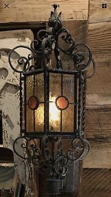 Whether the choice is a tiered look or single votive, wrought iron will maintain its luster for years. Beautiful hand forged wrought iron sconce. Light amber and ...