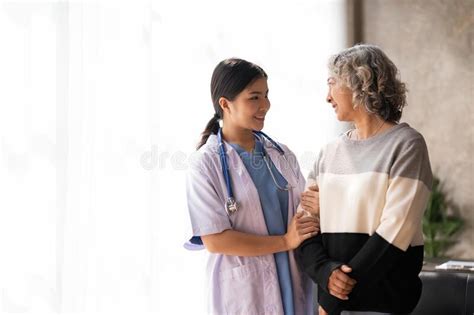 Young Caregiver Helping Senior Woman Walking Nurse Assisting Her Old