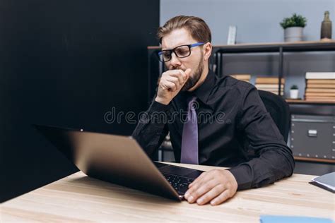 Mature Man Yawning At Office Because Of Feeling Tired Stock Photo