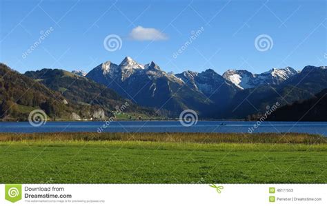 Snow Capped Mountains Lake And Green Meadow Stock Image Image Of