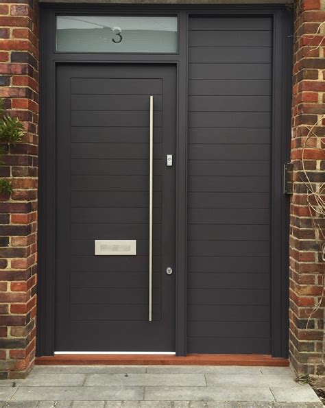 stylish front door with a bright modern finish and brass door furniture the opaque sidelight