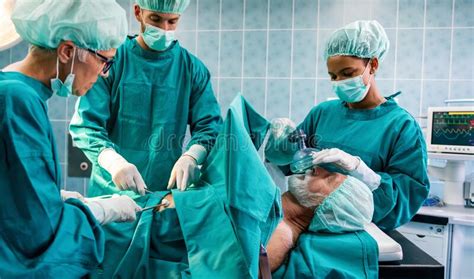 Group Of Surgeon Doctor Team At Work In Operating Room Stock Image