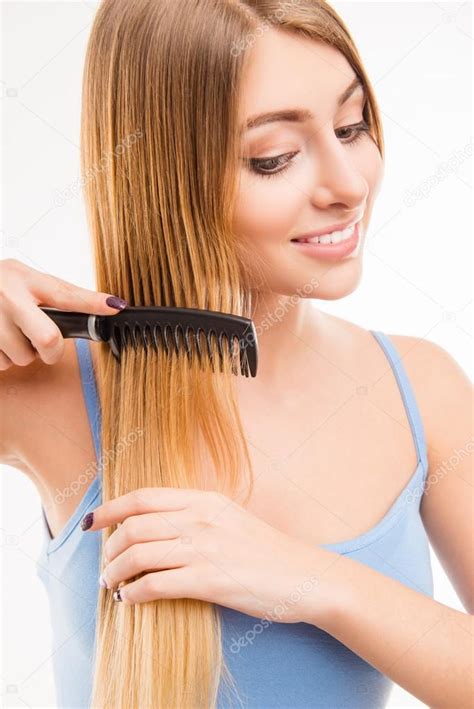 Girl Combing Her Hair Close Up Photo Stock Photo By Deagreez