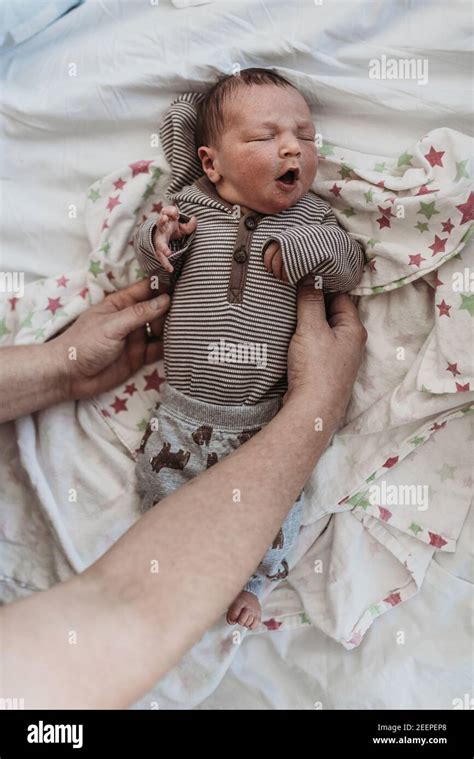Newborn Baby Boy Held By Dad On Hospital Bed Stock Photo Alamy