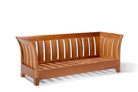 Wicker patio set with beige cushions standing on a wooden board deck. The Karmin sofa without cushion shows solid wood slats backrest ans seat | Wooden sofa set ...