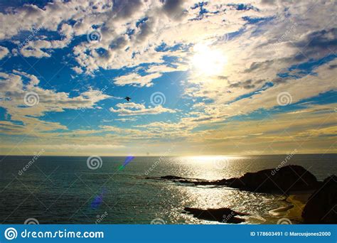 Gorgeous View Of The Beach At Sunset With Blue Ocean Water