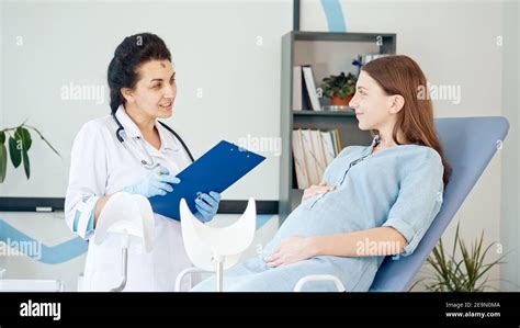 Happy Pregnant Woman Visit Gynecologist Doctor At The Medical Clinic Female Doctor Examine