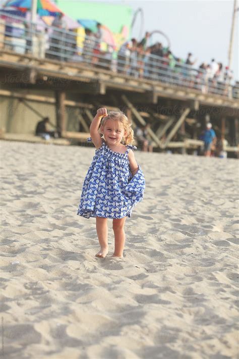 Toddler Wearing Blue And White Checkered Sundress At Beach By Stocksy