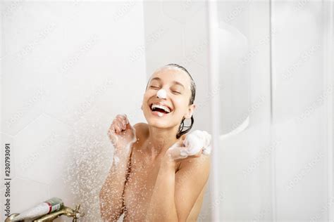 Portrait Of A Happy Naked Woman Playing With Soap Foam In The Shower