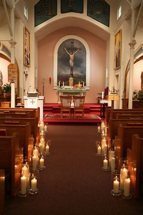 Clusters Of Pillar Candles Cast A Warm Glow Over The Church In