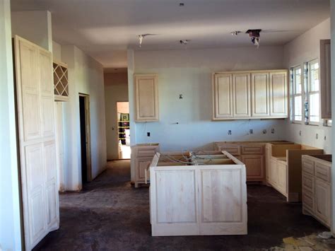 Your kitchen was designed and built just for you, by artisans who are passionate about getting every detail just right. Unfinished kitchen cabinets, being painted now ...