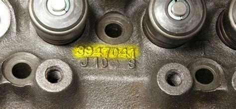 An Engine Block With The Number 350 On Its Left Side And Yellow Sticker