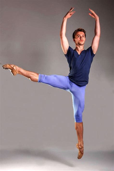 A Man In Blue Shirt And Shorts Doing A Dance Pose