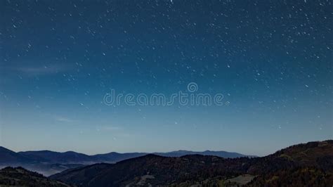 Nigh Starry Sky Above Forestry Mountains And Hills At Dusk Stock