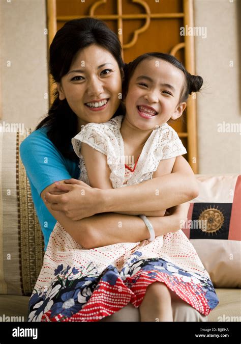 Mother And Daughter Embracing And Smiling Stock Photo Alamy
