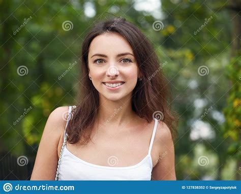 Close Up Portrait Of Young Beautiful Brunette Woman With Adorable Smile