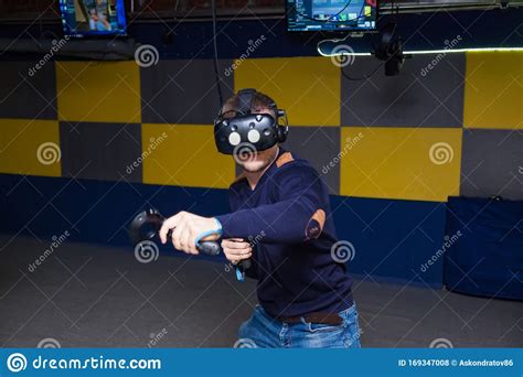 The Guy Plays A Fight Connected To Virtual Reality In A Helmet With
