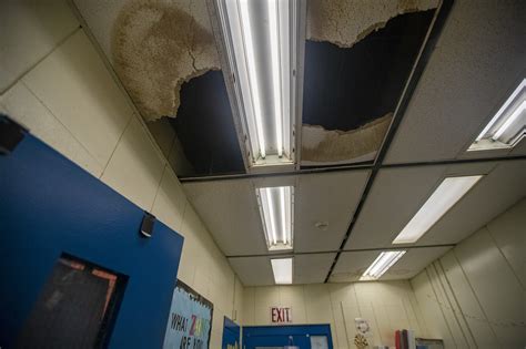 Falling Ceiling Tiles And Rusty Windows Inside A Boston School