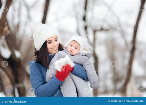 Mother Showing Her Baby Snow For The First Time Stock Image Image Of