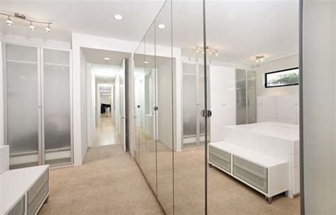 Floor to ceiling cabinets provide a closet or cupboard for storage. Mirrored Doors & Mirror Molding