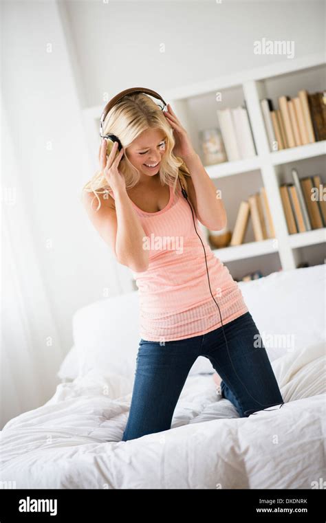 Young Woman Listening To Music In Bedroom Stock Photo Alamy