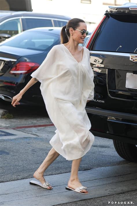 Angelina Jolie Wearing A White Dress And Matching Slides Angelina