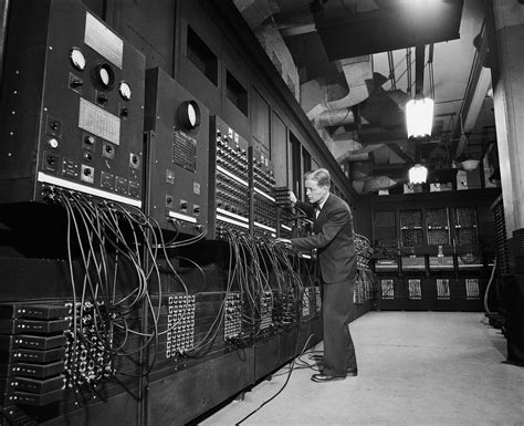 An Old Black And White Photo Of A Man Working On Electrical Equipment