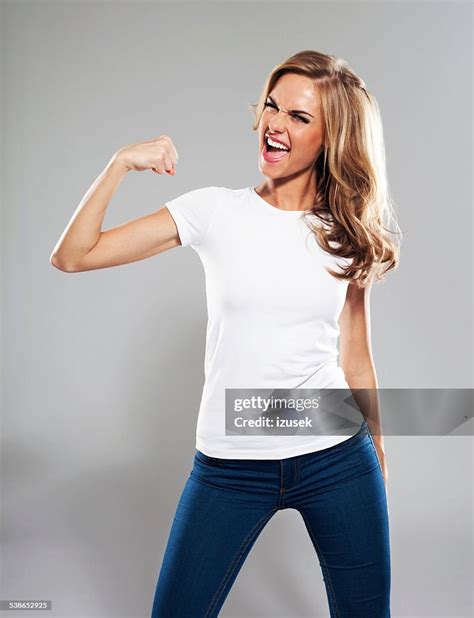Excited Young Woman Flexing Her Bicep Studio Portrait High Res Stock