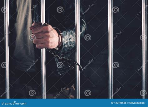 Handcuffed Man Behind Prison Bars Stock Photo Image Of Jailbird
